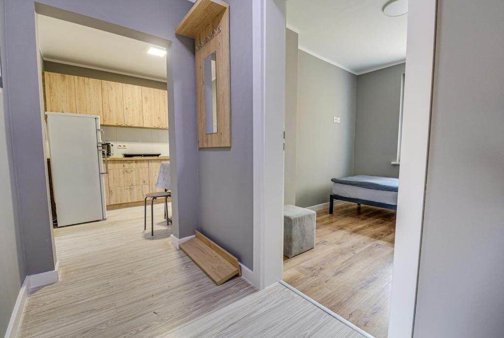 an open hallway with a kitchen and a refrigerator at 2B 3 rooms 43,06qm apartment newly renovated, 5 beds in Schwedt