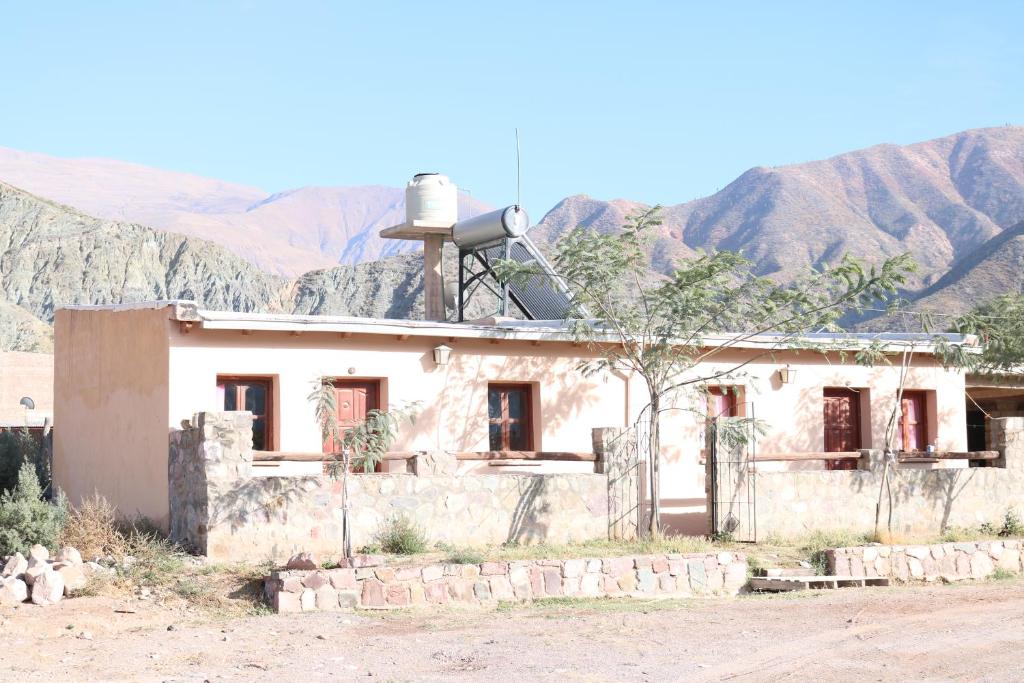 an old house with a water tank on top of it at Establecimiento turistico LAS AMARAS in Tumbaya