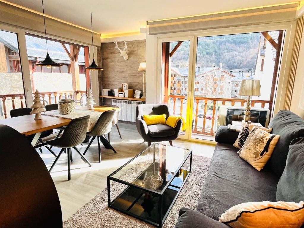 a living room with a couch and a table at UP BENASQUE FLOR de NIEVE in Benasque