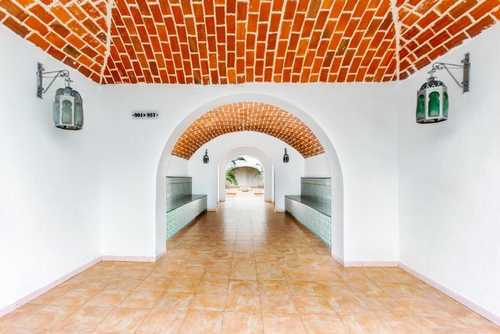 an archway with an orange roof in a building at Iris Hotel & Thalasso in Taguermess