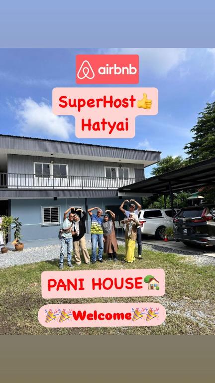a group of people standing in front of a paint house at Pani House Hatyai 4 in Hat Yai