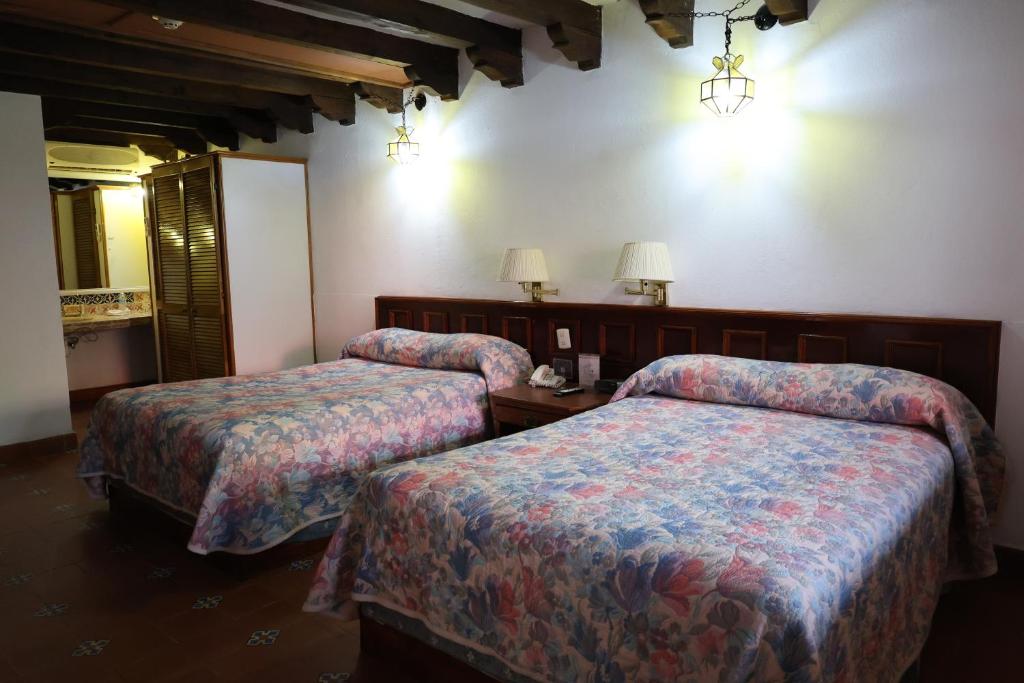 Postel nebo postele na pokoji v ubytování Hotel Posada Vista Bella