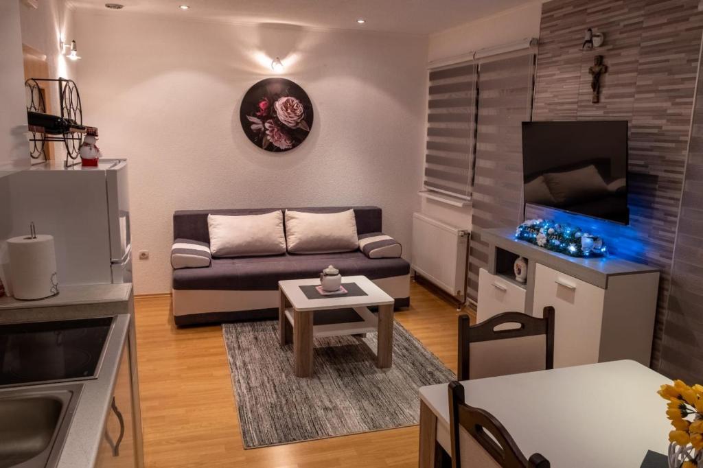 a living room with a couch and a table at Apartman KIKI in Kupres