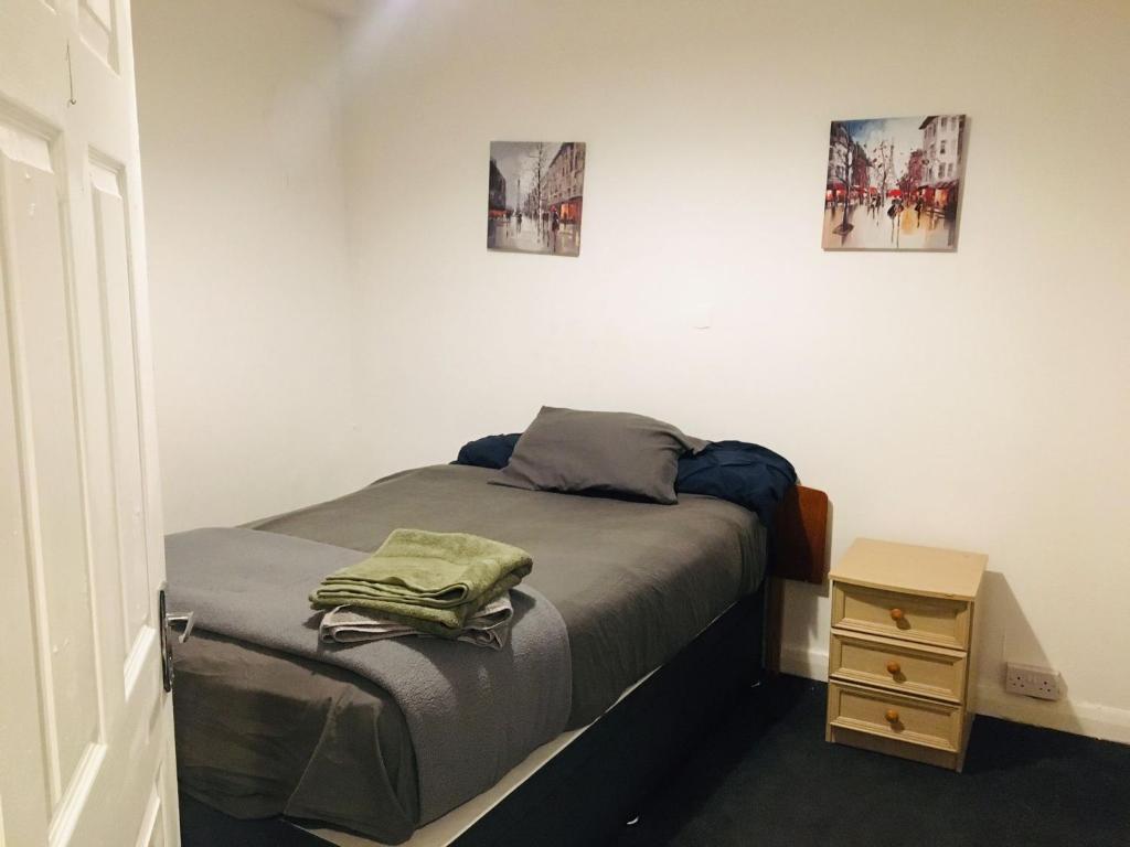 a small bedroom with a bed and a night stand at Hagley Road West House in Birmingham