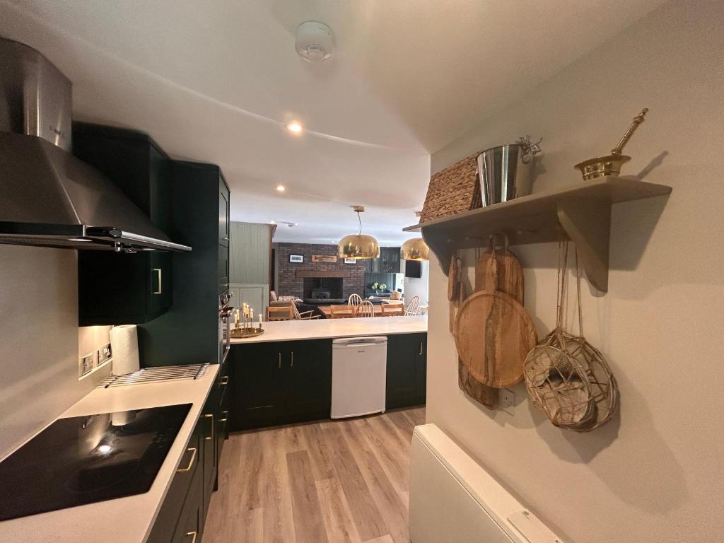 a kitchen with black and white cabinets and a counter at Aldernaig Mill in Invergarry