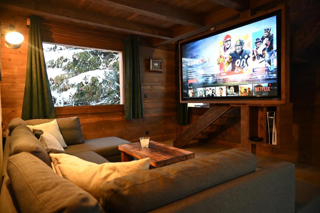 Televízia a/alebo spoločenská miestnosť v ubytovaní Chalet Montana