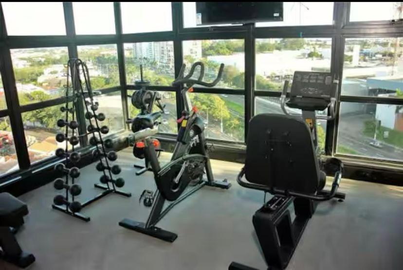 a gym with two exercise bikes in front of a window at Apto alto padrao ao lado do IBIS - Av Esmeraldas in Marília