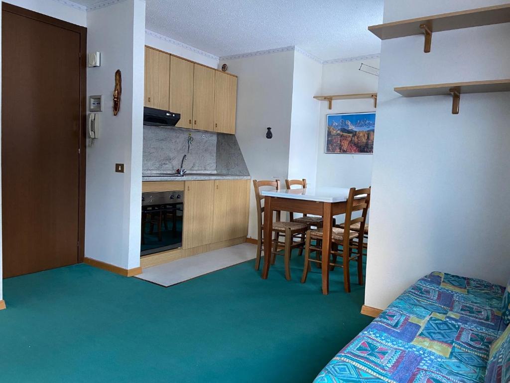 a kitchen and dining room with a table and chairs at Mountain View in Passo del Tonale