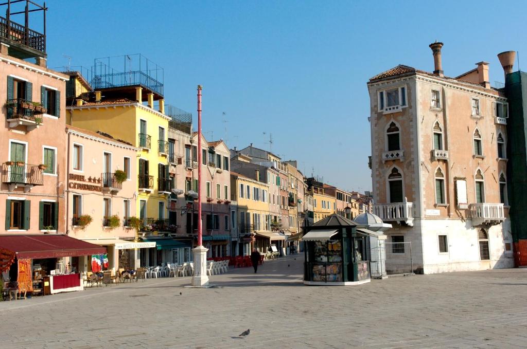 a city street with buildings and a clock tower at Hotel Ca&#39; Formenta in Venice