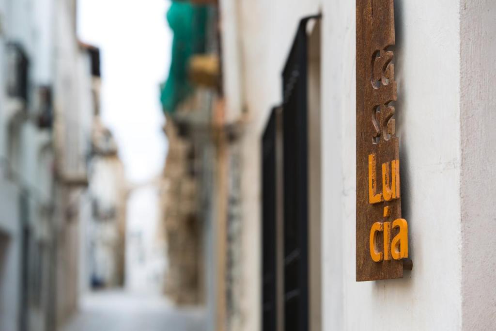 a wooden sign on the side of a building at Casa Lucía in Requena