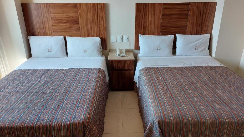 Postel nebo postele na pokoji v ubytování Hotel Real Del Sol - Zona Expo Industrial