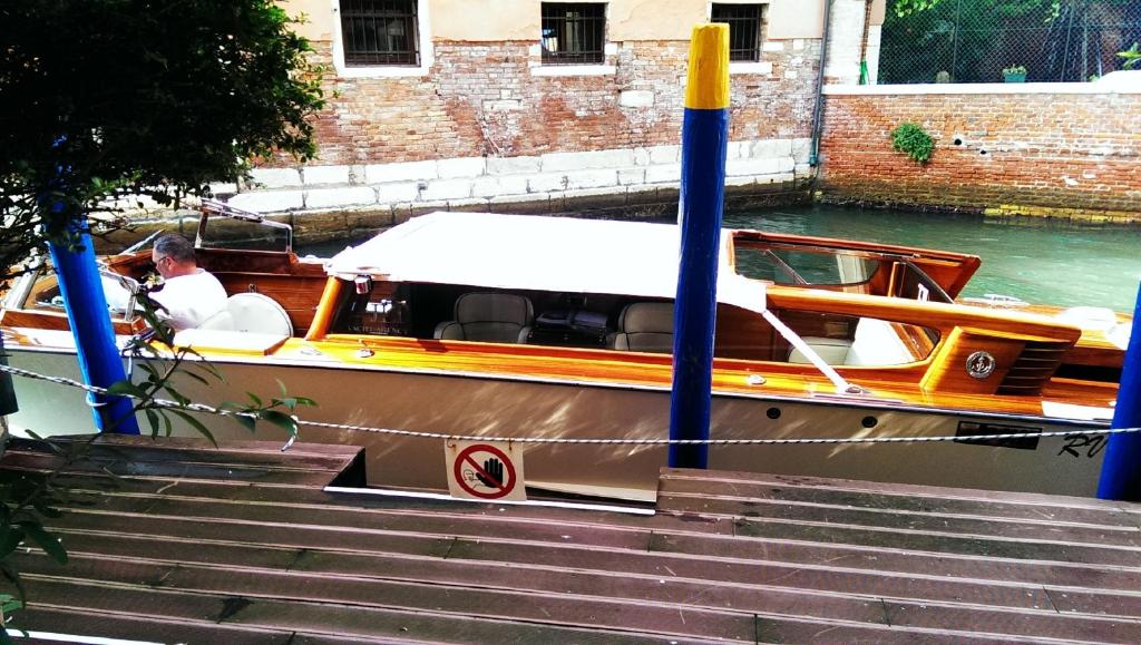 a boat is docked next to some stairs at Hotel Ca&#39; Formenta in Venice