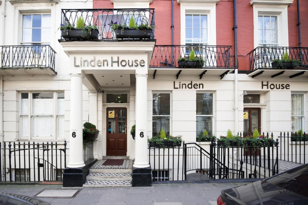 a white building with a lincoln house at Linden House Hotel in London