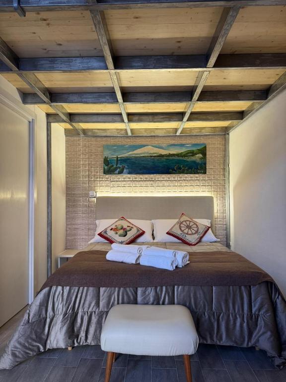 a bedroom with a bed with a wooden ceiling at Attardo's House in Catania