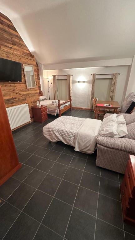 a large room with two beds and a table at 55A Castlewellan Main Street in Castlewellan