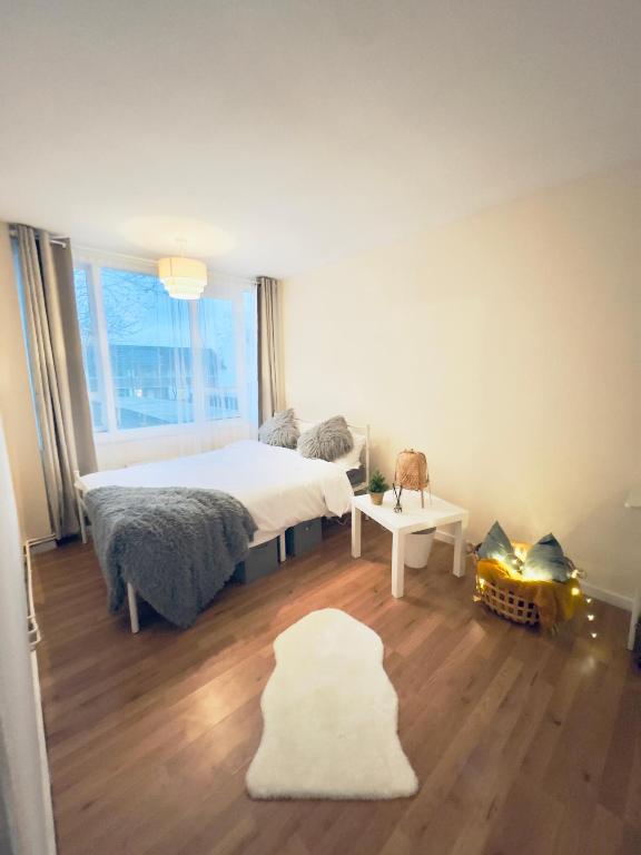 a bedroom with a bed and a large window at Cozy Urban Scape in London