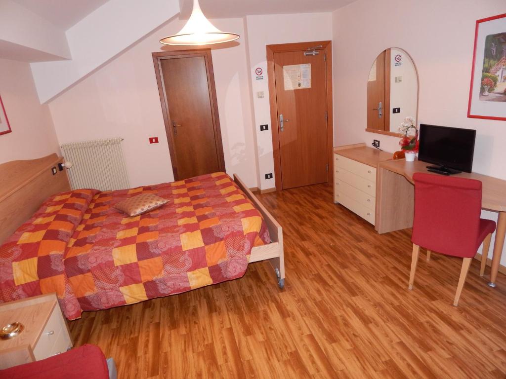 Postel nebo postele na pokoji v ubytování Albergo Ginevra
