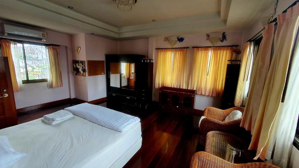 a bedroom with a white bed and two chairs at Honey Moon view in Bophut 