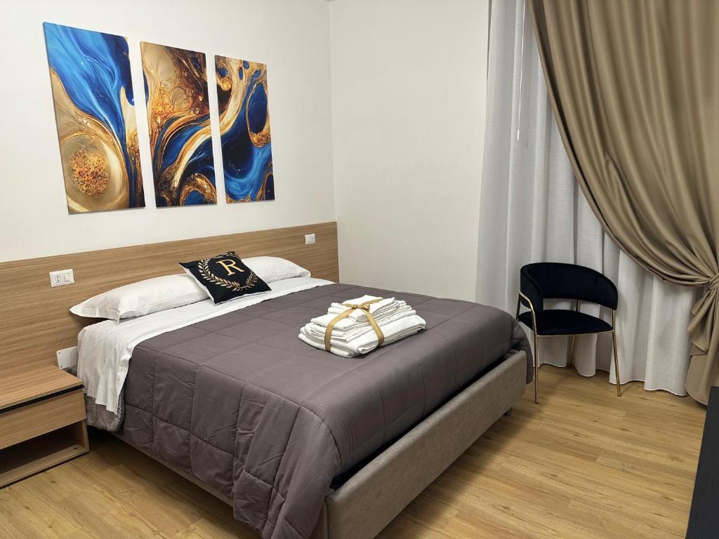 a bedroom with a bed and a painting on the wall at Royal Residence in Santa Maria Capua Vetere