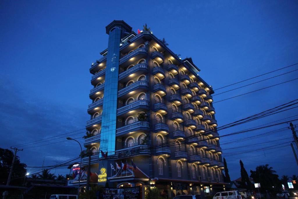a large blue building with lights on it at King Fy Hotel in Battambang