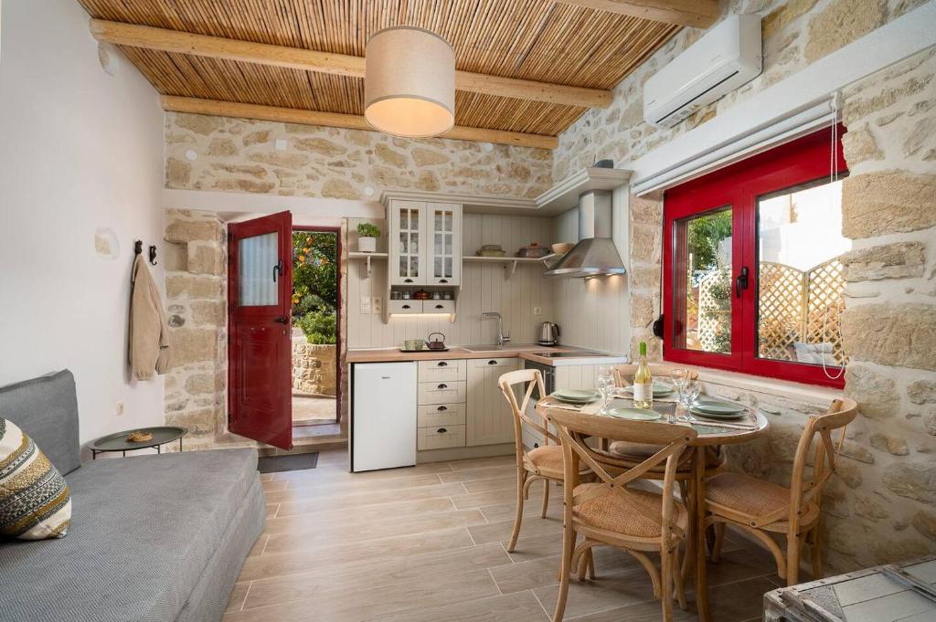 a kitchen with a table and chairs in a room at Physis Country House 2 Near Matala Beach & Faistos in Kousés