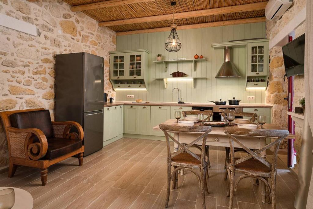 a kitchen with a table and a refrigerator at Physis Country House Near Matala Beach & Faistos in Kousés