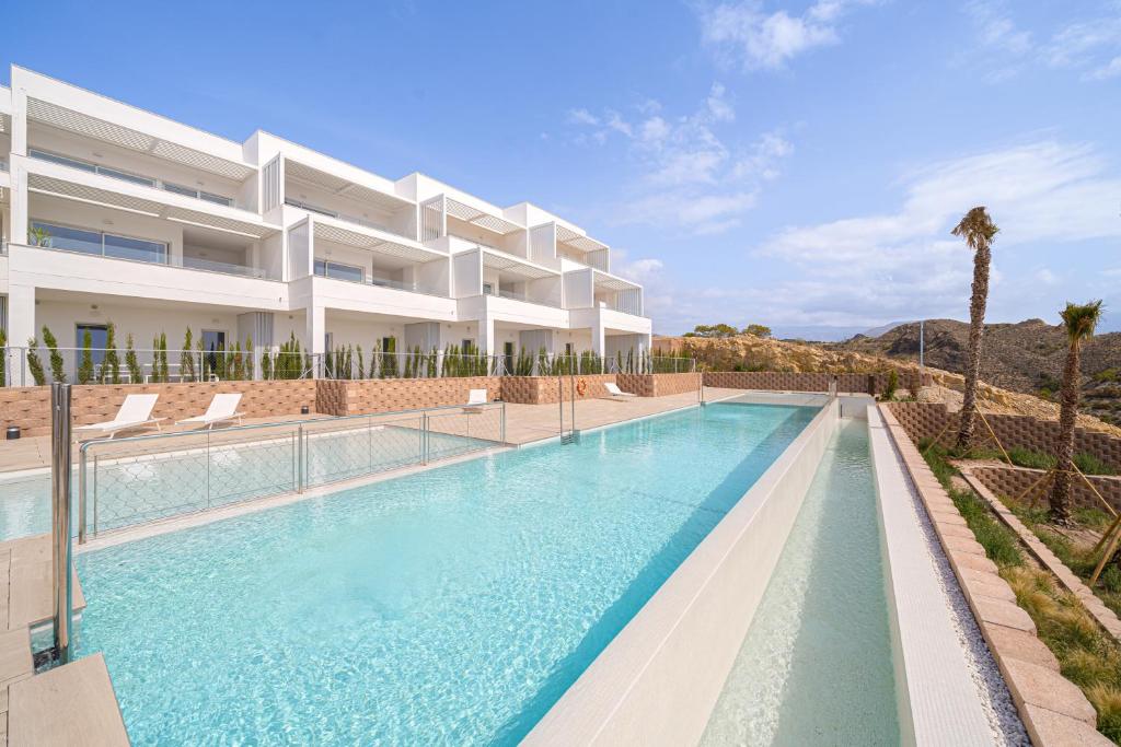 a large swimming pool in front of a building at La Vila - Bolnou Seaviews in Villajoyosa
