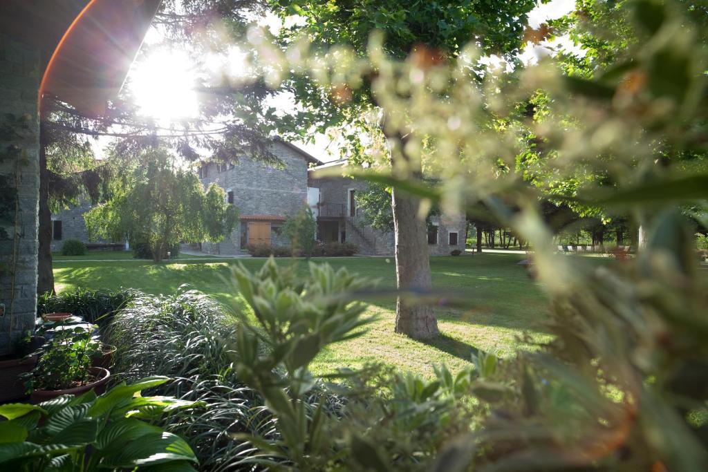 a garden with a house in the background at Cascina Borgofrancone in Gera Lario