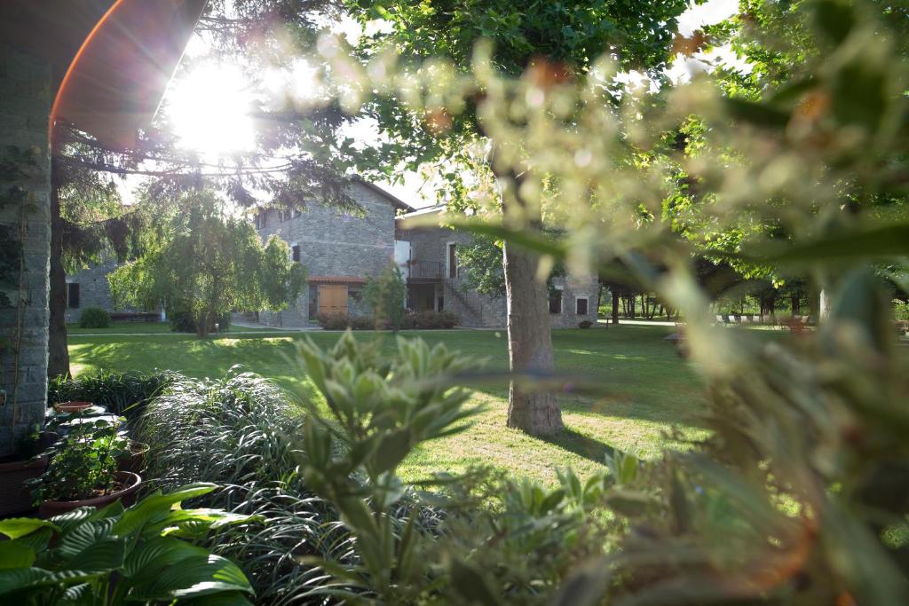 einen Garten mit einem Haus im Hintergrund in der Unterkunft Cascina Borgofrancone in Gera Lario