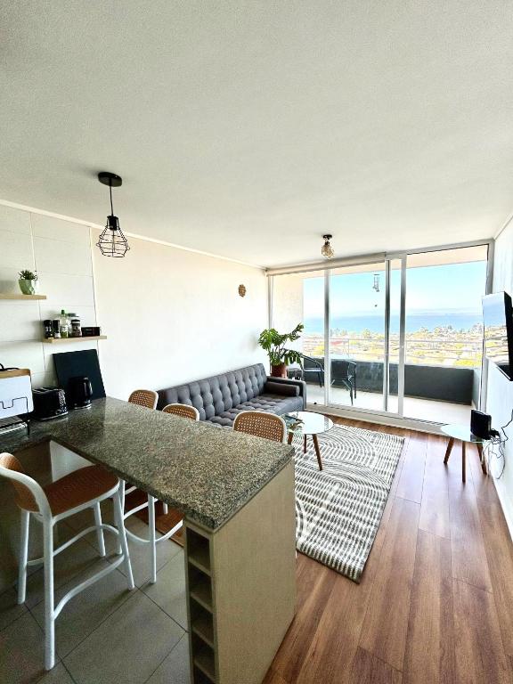 a living room with a couch and a table at Monkey Guest Apartment in Concón