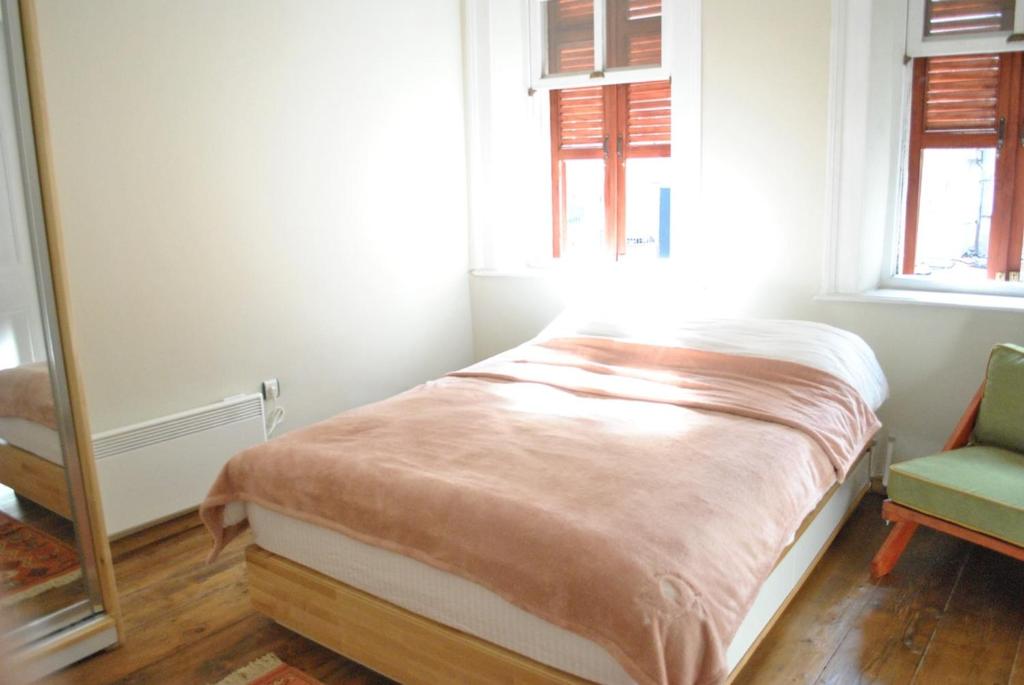 a small bedroom with a bed and a mirror at Maris Greek House in Konak