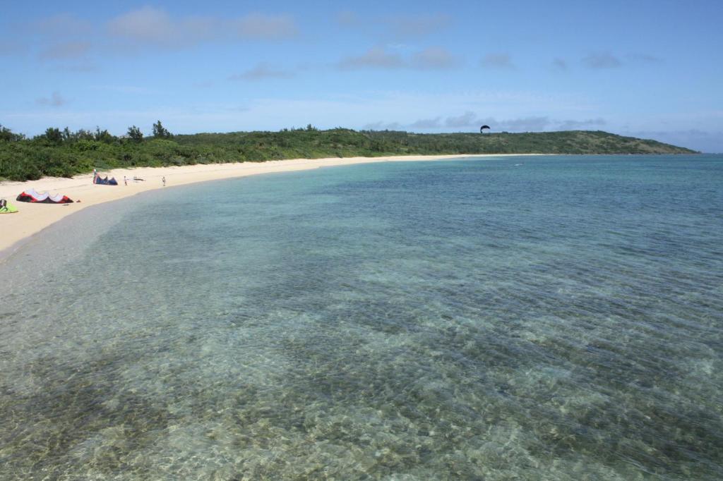 an island in the ocean next to a beach at Guest House Miyakojima in Miyako-jima