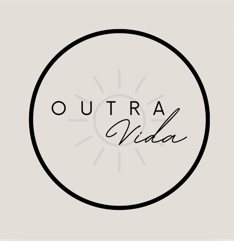 a black and white circle with the words urra vida at Outra Vida in Mértola