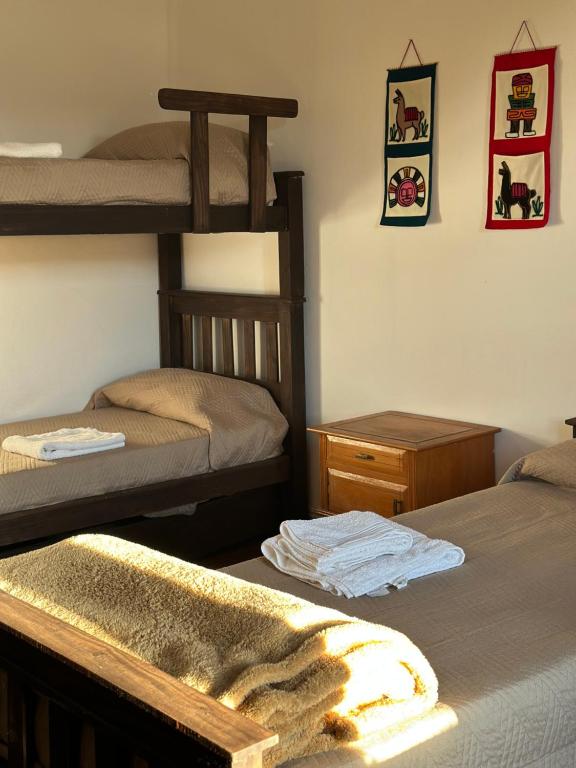 a bedroom with two bunk beds and a towel at Casa Ciao in Deán Funes