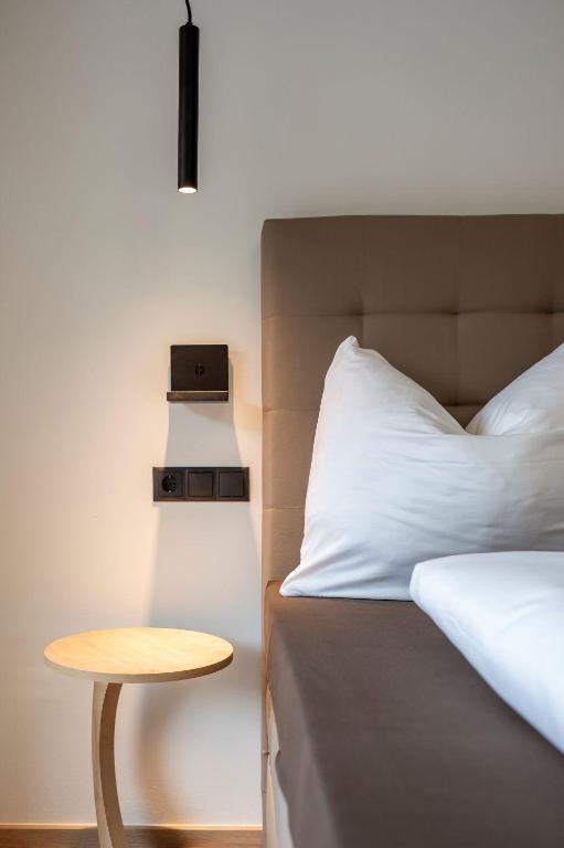 Postel nebo postele na pokoji v ubytování Goldhirsch Aparthotel