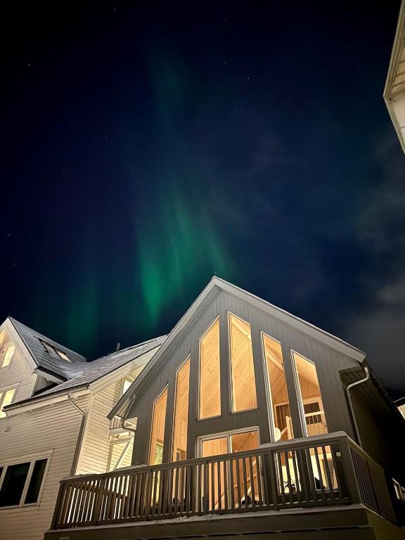 a house with the aurora in the sky at Cathedral Lodge in Tromsø