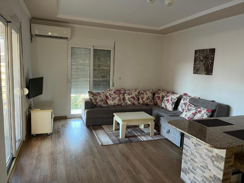 a living room with a couch and a table at Apartments Visar in Ulcinj