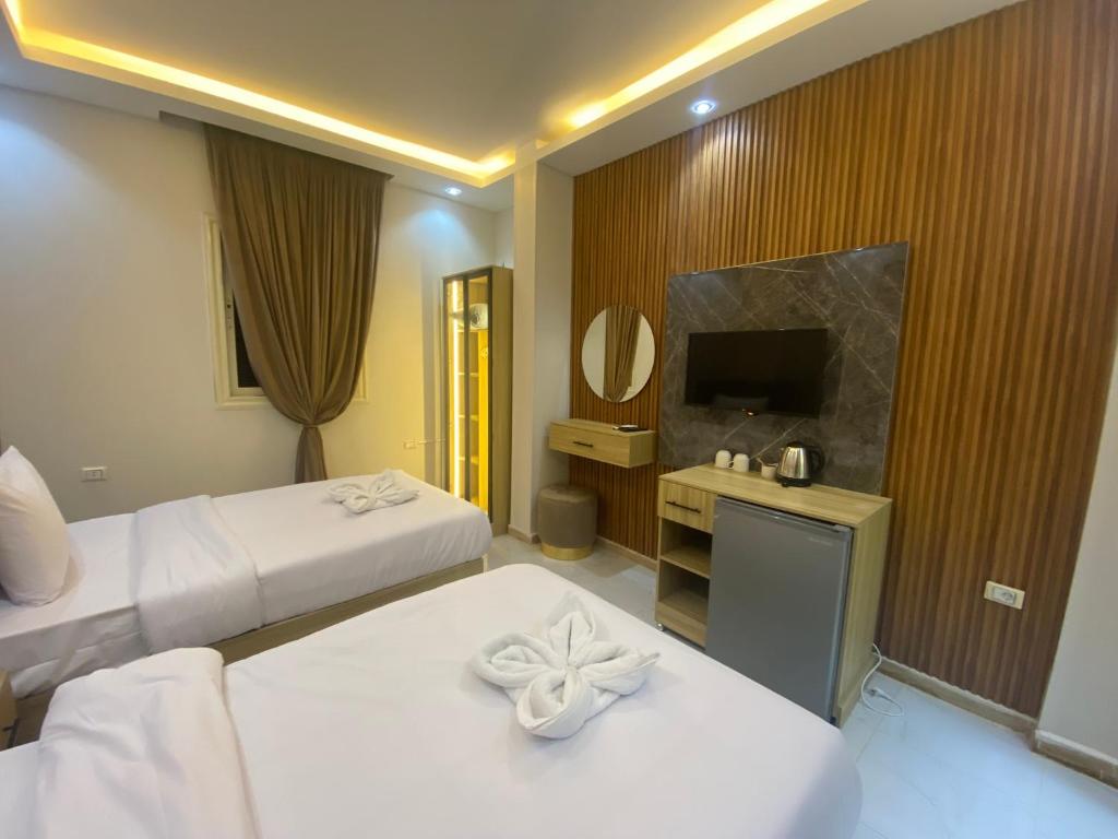 Postel nebo postele na pokoji v ubytování Giza Pyramids Boutique Hotel