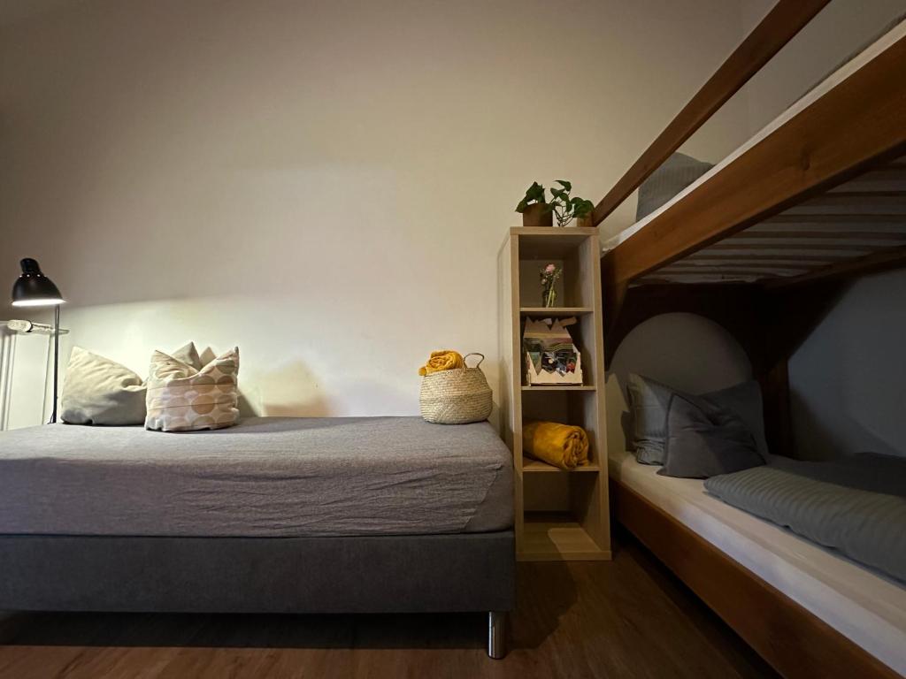 a bedroom with a bed and a bunk bed at Pension Almhof Baumgarten in Bad Reichenhall