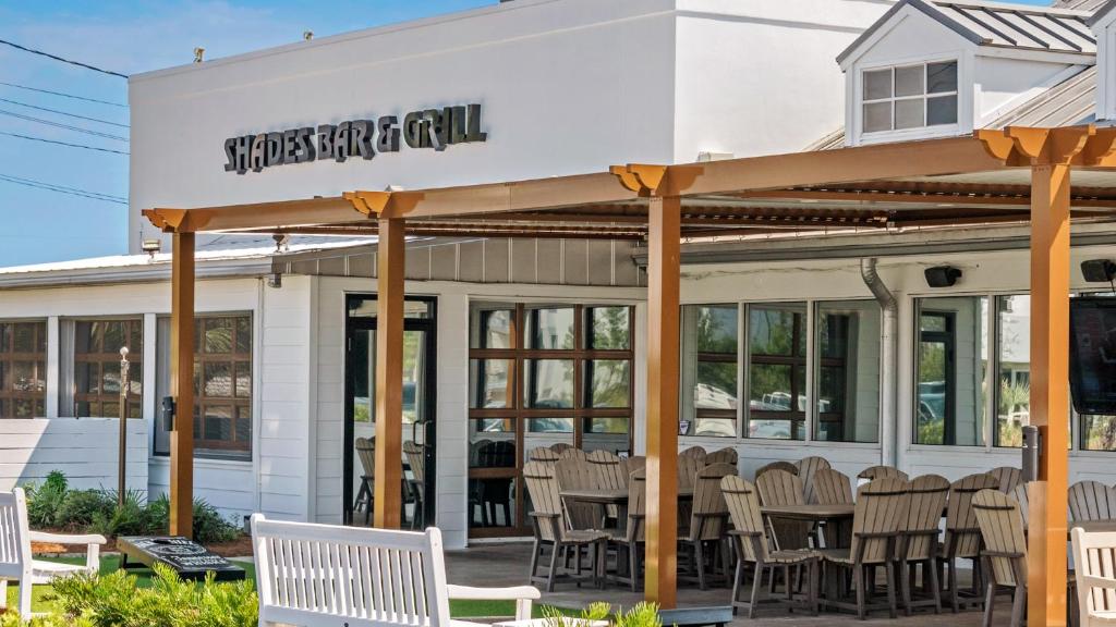 a restaurant with chairs in front of a building at Lazy Days in Seacrest