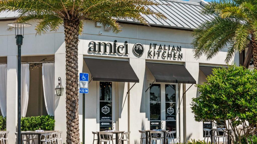a restaurant with tables and chairs in front of a building at Lazy Days in Seacrest