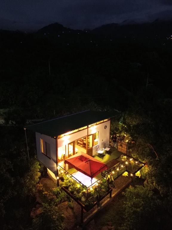 an aerial view of a house at night at Glamping Entre Rocas Tena in Tena