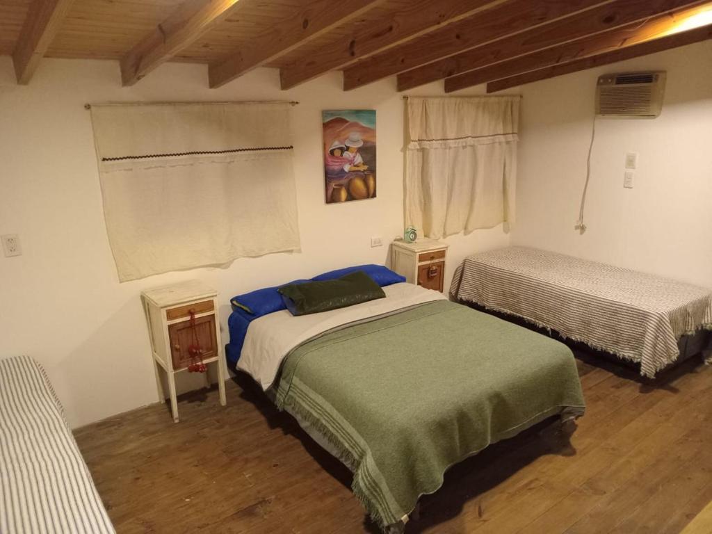 a bedroom with two beds in a room at Casa wairaluna in Capilla del Monte