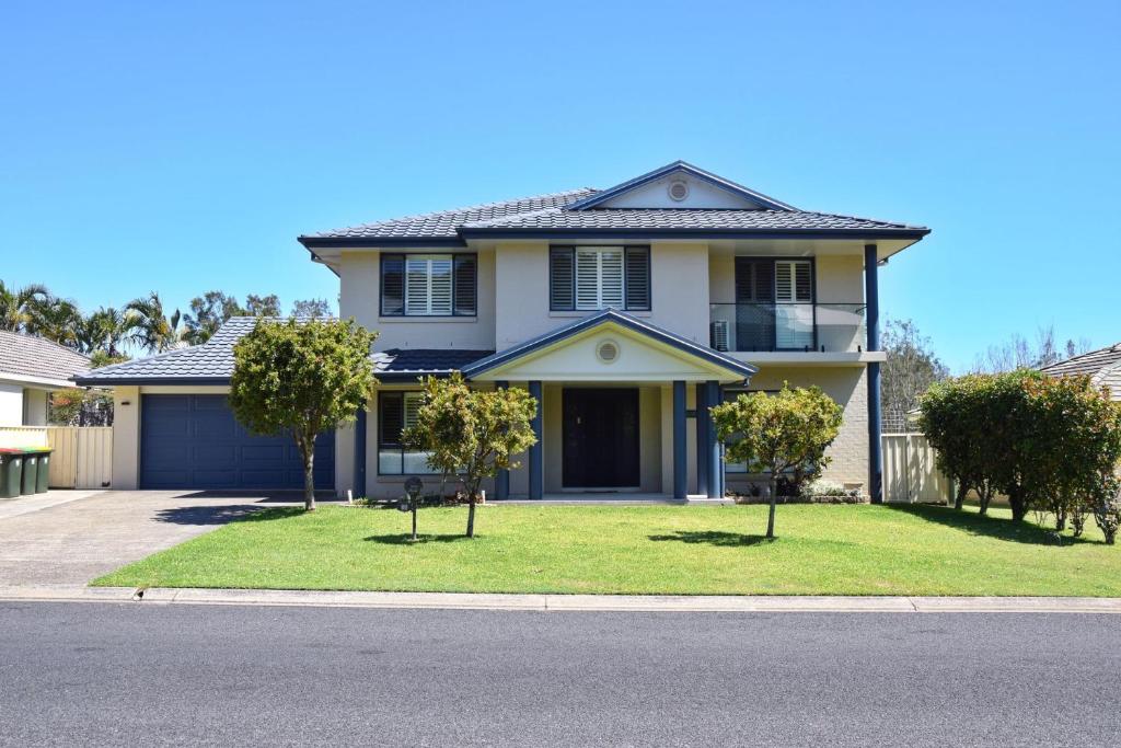a house with two trees in the front yard at Jaspa - River Views - Bring your own linen in South West Rocks