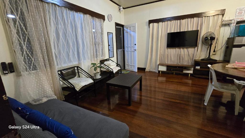 a living room with a couch and a table at Hillside Vacationers homestay in Baguio