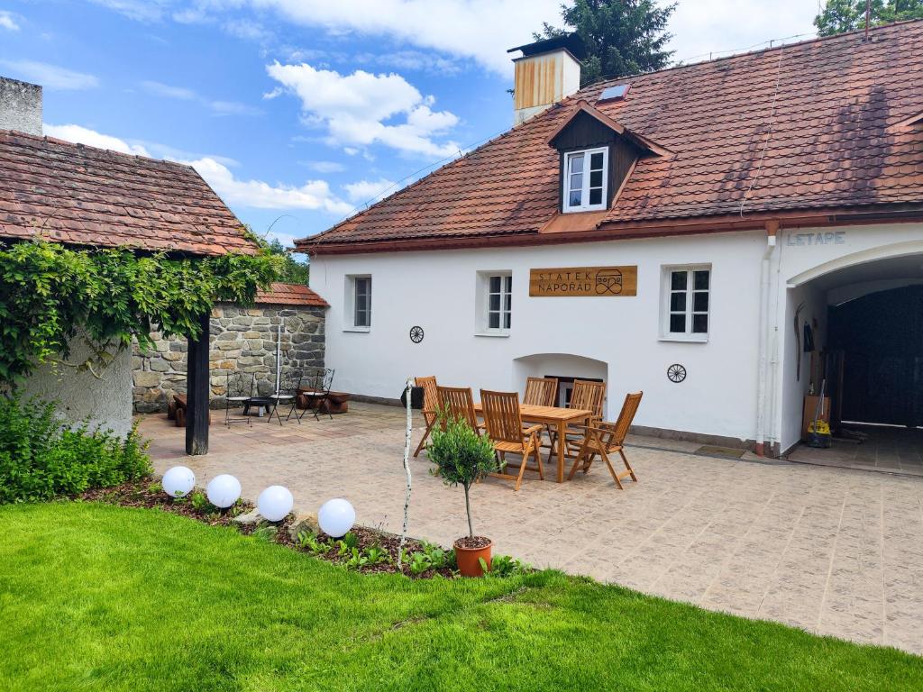 a house with a patio and a table and chairs at Statek Napořád in Předslavice