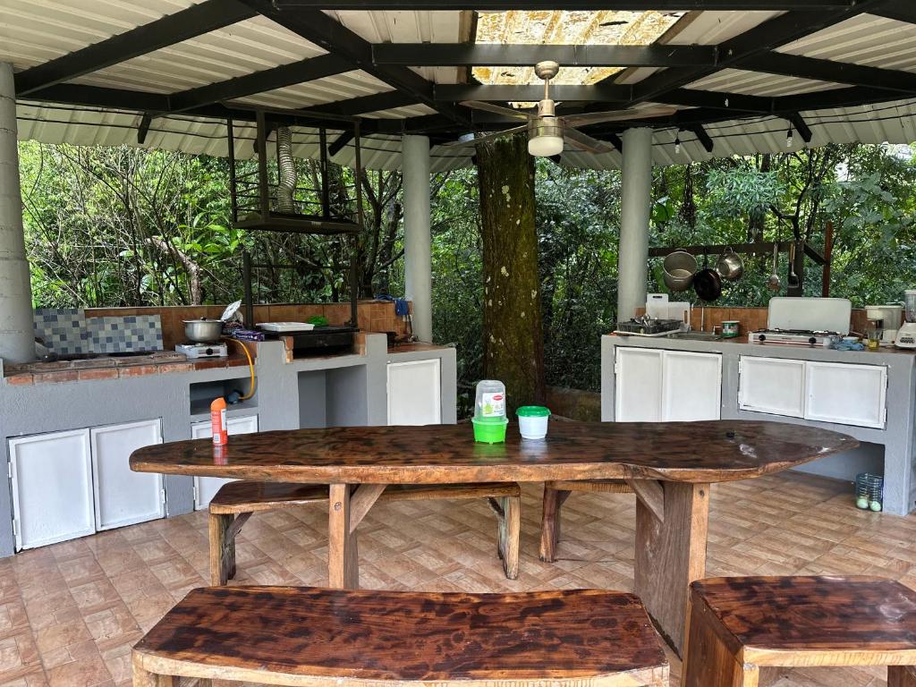 a large wooden table in an outdoor kitchen at Hostal Lopez El Valle Cabañas in El Valle
