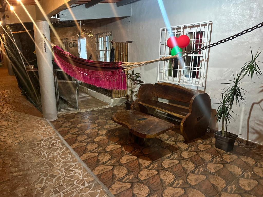 a room with a hammock and a bench and balloons at Hostal Lopez El Valle Cabañas in El Valle