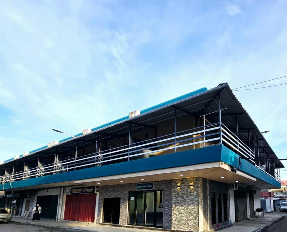 a building with a balcony on top of it at Grand Luxury Hotel Semporna in Semporna