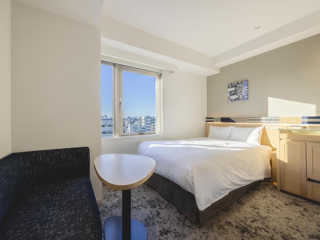 Postel nebo postele na pokoji v ubytování Hotel Gracery Asakusa